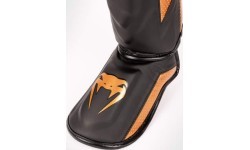 Venum Elite Evo apakšstilbu sargi, melni/bronzas